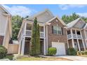 Charming two-story home with brick facade, second-story balcony, and attached one-car garage at 6341 Lake Valley Pt, Lithonia, GA 30058