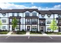 Attractive row of townhomes in a modern style, showing landscaping and exterior details on a sunny day at 1104 Knoxboro Ln, Woodstock, GA 30188