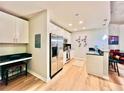 Modern kitchen with white cabinets, stainless steel appliances, and black countertops at 400 W Peachtree Nw St # 2704, Atlanta, GA 30308