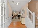 Inviting foyer with hardwood floors, staircase, and views of the living area; the space is brightly lit with natural light at 5865 El Segundo Way, Atlanta, GA 30349