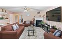Cozy living room featuring a fireplace, ceiling fan, and comfortable seating; the perfect space to relax and unwind at 5865 El Segundo Way, Atlanta, GA 30349