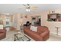 Spacious living area featuring a ceiling fan, carpet flooring, and seamless flow to the dining area at 5865 El Segundo Way, Atlanta, GA 30349