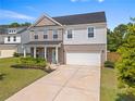 Beautiful two-story home with a well-maintained lawn, an attached two-car garage, and classic architectural details at 113 Poppy St, Mcdonough, GA 30253
