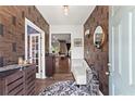 Elegant foyer showcasing decorative wallpaper, hardwood floors, stylish furnishings, and an inviting ambiance at 113 Poppy St, Mcdonough, GA 30253