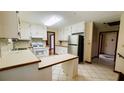 Bright kitchen with white cabinets, tiled floors, and new stainless steel refrigerator at 494 Rue Montaigne, Stone Mountain, GA 30083