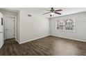 Bedroom with wood-look floors, bright window, and a ceiling fan at 2825 Northeast Ne Expy # F003, Atlanta, GA 30345