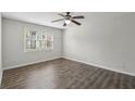 Bright bedroom featuring wood-look flooring, a ceiling fan and a window with natural light at 2825 Northeast Ne Expy # F003, Atlanta, GA 30345