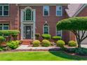 Well-maintained brick home with professionally landscaped front yard at 545 Ashvale Overlook, Alpharetta, GA 30005