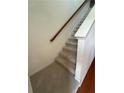 Carpeted staircase featuring hardwood banister at 1392 Weatherbrook Cir, Lawrenceville, GA 30043