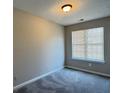 Neutral bedroom with large window and plush gray carpet at 4044 Robin Cir, Atlanta, GA 30349