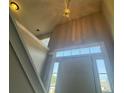 Bright entryway with high ceilings, decorative light, and staircase at 4044 Robin Cir, Atlanta, GA 30349