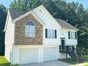Charming two-story home with a stone facade and attached two-car garage at 4044 Robin Cir, Atlanta, GA 30349