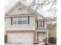 Charming two-story home with brick accents and attached garage on a landscaped lot at 646 Lakes Cir, Lithonia, GA 30058