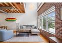 Inviting living space featuring exposed wood ceilings, a gray sofa, and natural light at 322 Peters Sw St # 2, Atlanta, GA 30313