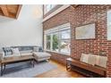Modern living room featuring a brick accent wall, large windows, and hardwood floors at 322 Peters Sw St # 2, Atlanta, GA 30313