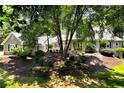 Inviting gray two-story home featuring manicured lawn, mature trees, and tasteful landscaping at 4882 Rabbit Farm Road Rd, Loganville, GA 30052