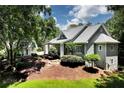 Inviting gray two-story home with manicured lawn, mature trees, and detached garage at 4882 Rabbit Farm Road Rd, Loganville, GA 30052