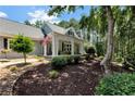 Charming covered porch with classic columns and patriotic American flag at 4882 Rabbit Farm Road Rd, Loganville, GA 30052
