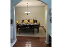 Elegant dining room with hardwood floors, decorative lighting, and ample space for entertaining guests at 6432 Polar Fox Ct, Riverdale, GA 30296