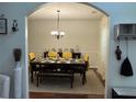 Elegant dining room featuring hardwood floors, a chandelier, and a beautifully set table for formal dining at 6432 Polar Fox Ct, Riverdale, GA 30296