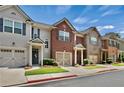 A row of charming townhomes, each featuring a one-car garage and well-kept lawns at 1384 Dolcetto Nw Trce, Kennesaw, GA 30152