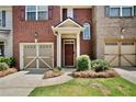 Attractive brick townhome with a one-car garage and inviting front entrance at 1384 Dolcetto Nw Trce, Kennesaw, GA 30152