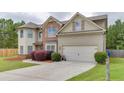 Charming two-story home featuring a manicured lawn, brick accents, and an attached two-car garage at 1548 Station Ridge Dr, Lawrenceville, GA 30045
