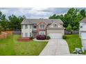 Charming two-story home with a well-manicured lawn, attached garage, and inviting curb appeal at 1548 Station Ridge Dr, Lawrenceville, GA 30045