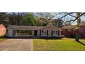 A well-kept single-story house boasts a convenient carport and tidy landscaping, offering curb appeal at 2830 Norgate Ln, Decatur, GA 30034