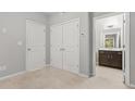 Cozy bedroom with carpeted floors, double closets and a view into the en-suite bathroom at 772 Aerial Se Way, Atlanta, GA 30312