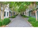 Scenic view of the townhouse lined street with mature trees and manicured landscaping at 772 Aerial Se Way, Atlanta, GA 30312