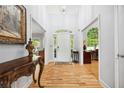 Inviting foyer features hardwood floors, high ceilings, and an arched doorway with views of the study at 908 Lance Cir, Lawrenceville, GA 30043