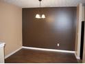 An empty dining room featuring hardwood floors, modern lighting, and neutral paint colors at 10103 Waldrop Pl, Decatur, GA 30034