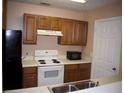 The kitchen features wooden cabinets, white countertops, and appliances at 10103 Waldrop Pl, Decatur, GA 30034