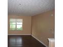 Bright living room features hardwood floors, a large window, and neutral-colored walls at 10103 Waldrop Pl, Decatur, GA 30034