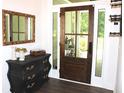 Elegant entryway featuring a wood door with sidelights and a stylish foyer table at 688 Harmony Rd, Temple, GA 30179