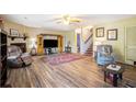 Open living room featuring hardwood floors, cozy furniture, and a decorative fireplace at 1919 Cheatham Woods Sw Dr, Marietta, GA 30008