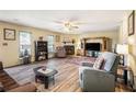 Spacious living room with hardwood floors, a fireplace, and abundant natural light at 1919 Cheatham Woods Sw Dr, Marietta, GA 30008