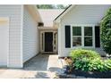 Close-up of the front entrance with tidy landscaping and a well-kept walkway leading to the door at 3050 Baymount Dr, Lawrenceville, GA 30043