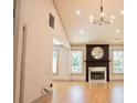 Spacious living room featuring hardwood floors, a fireplace with a mirror, and ample natural light at 3050 Baymount Dr, Lawrenceville, GA 30043