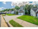 View of the house, showcasing the well-maintained lawn, concrete driveway and beautiful landscaping in a neighborhood at 4815 Price St, Forest Park, GA 30297