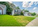 The house sits on a lush green lawn and features a two-car garage and beautifully designed brick facade at 4815 Price St, Forest Park, GA 30297