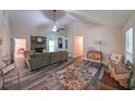 Spacious living room featuring a stone fireplace, vaulted ceilings, and stylish decor at 180 Kim Trail Trl, Stockbridge, GA 30281
