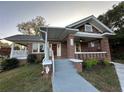Beautiful brick home showcasing a cozy covered porch and well-manicured lawn at 1134 Donnelly Sw Ave, Atlanta, GA 30310
