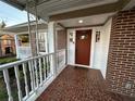 Inviting front porch featuring brick flooring and a charming 'hello' welcome mat at 1134 Donnelly Sw Ave, Atlanta, GA 30310