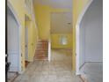 Open entryway with tile flooring, a staircase, and arched doorways offering a view into other rooms at 148 Barrington Pkwy, Stockbridge, GA 30281