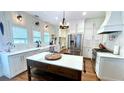 Bright kitchen with white cabinets, marble countertops, a center island, and stainless steel appliances at 420 Ashbury Cir, Dallas, GA 30157