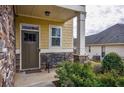 Inviting front porch with a charming bench, stone accents, and well-maintained landscaping at 963 Ensign Peak Ct, Lawrenceville, GA 30044