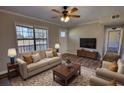 Cozy living room with ample seating, ceiling fan, and an abundance of natural light at 11 Grove Ln, Hampton, GA 30228