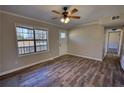 Bright living room featuring modern flooring and access to the entry door and hallway at 11 Grove Ln, Hampton, GA 30228